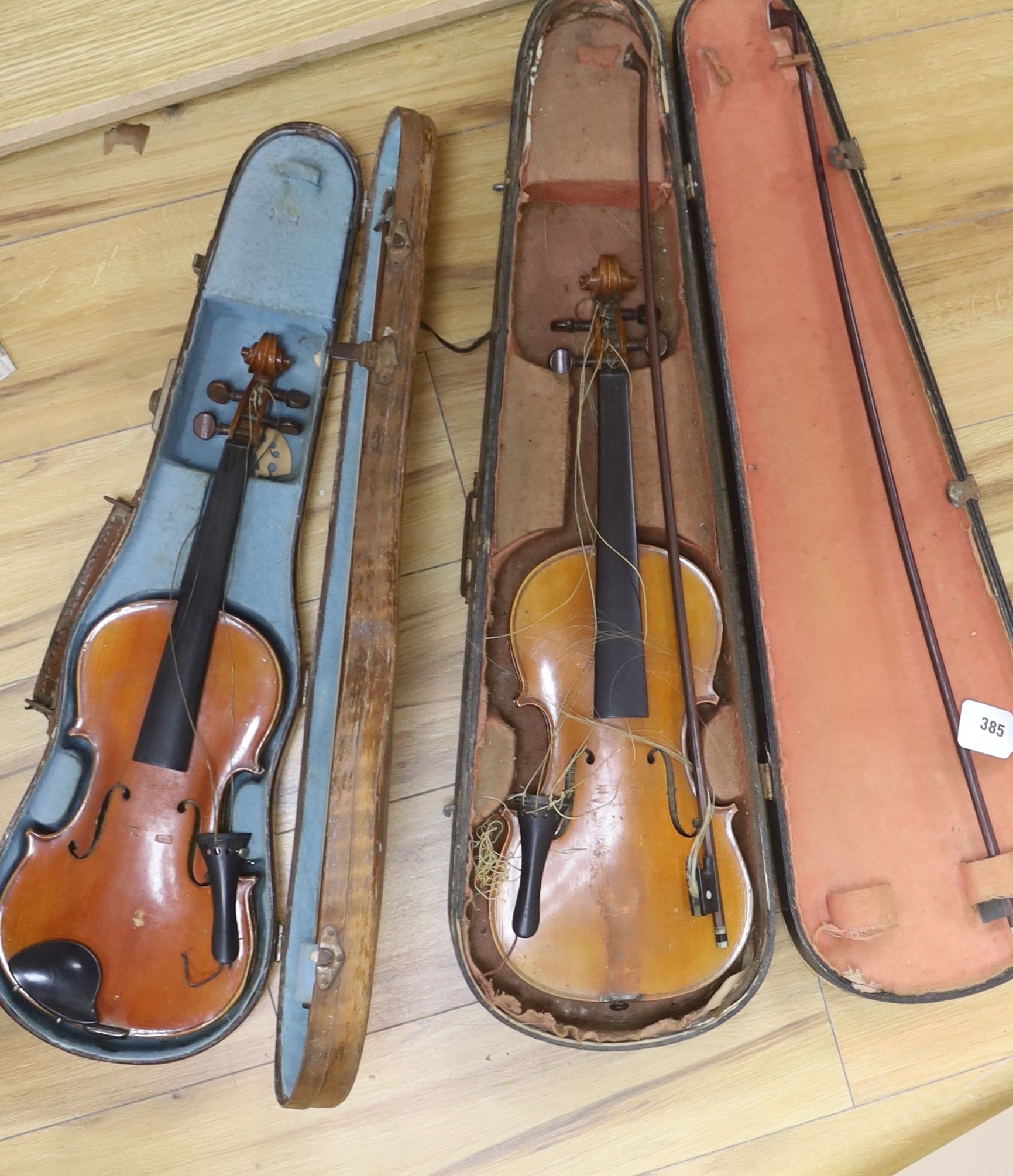 A Stradivarius copy violin and two bows and another bow, both cased, backs 33cm and 30cm